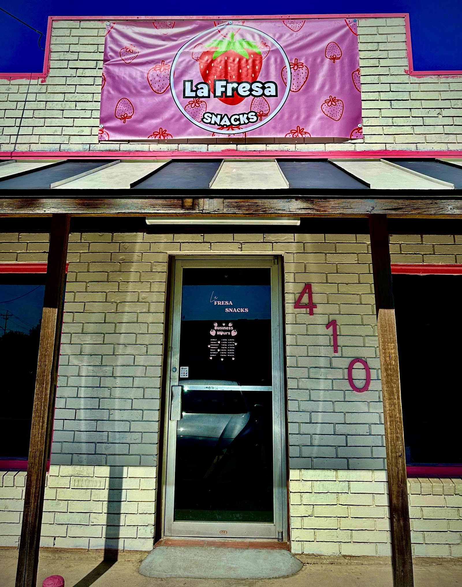 La Fresa Snacks storefront with pink strawberry banner in Seguin, TX
