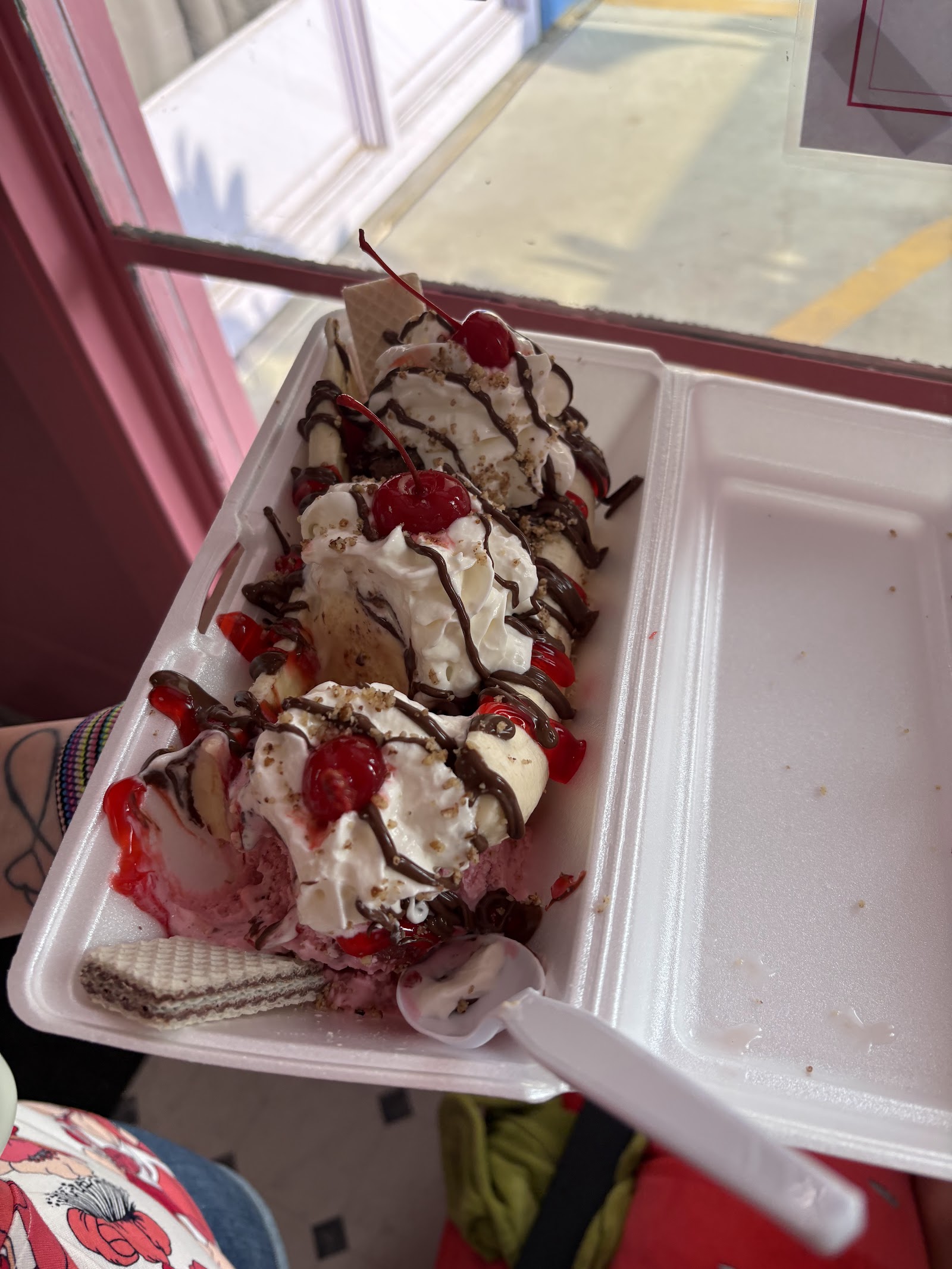 Banana split sundae with whipped cream and cherries